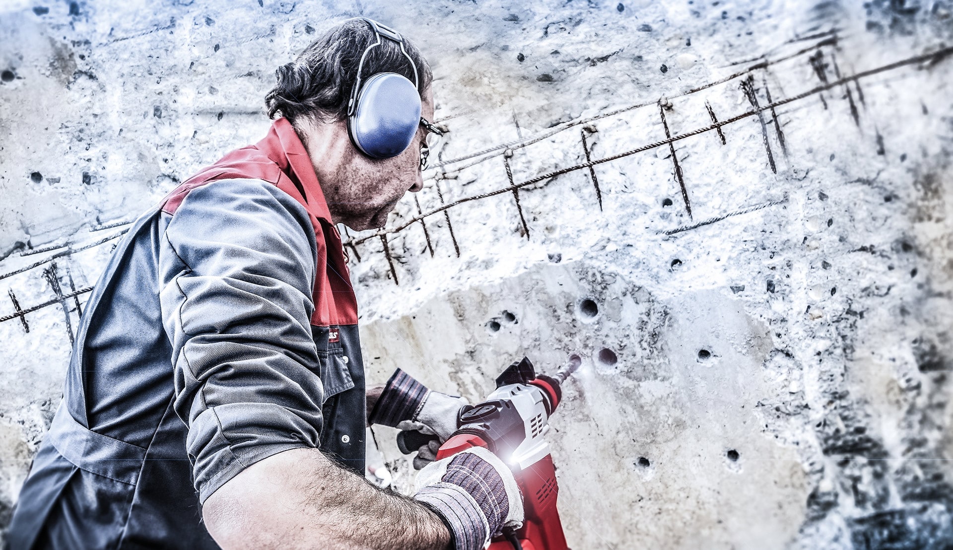 A man drill holes in a stone